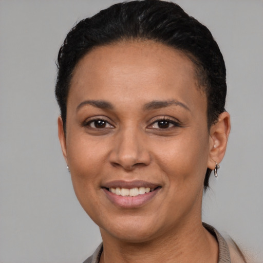Joyful latino young-adult female with short  black hair and brown eyes
