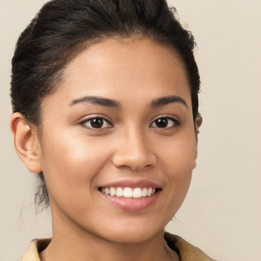 Joyful latino young-adult female with short  brown hair and brown eyes