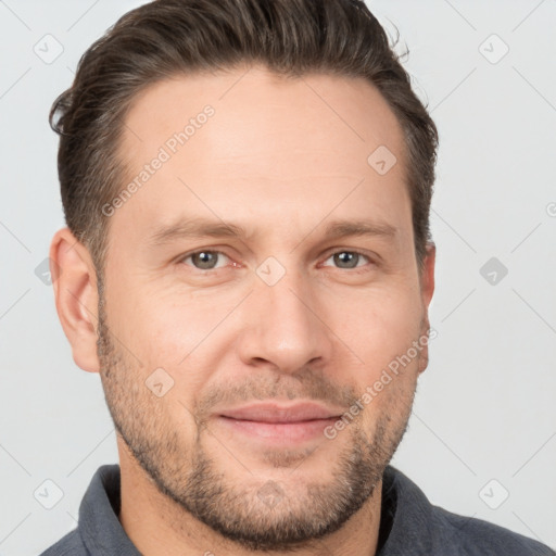 Joyful white adult male with short  brown hair and brown eyes