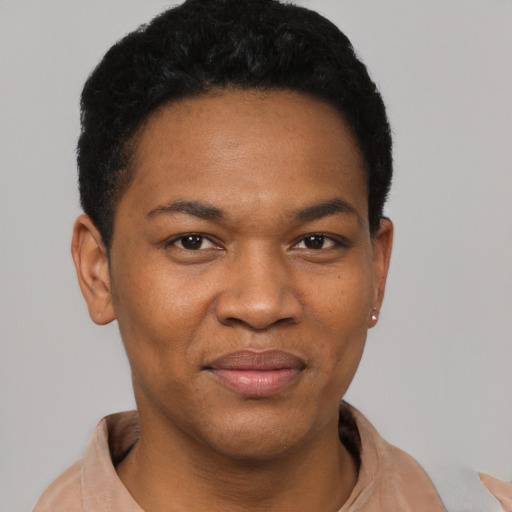 Joyful black young-adult female with short  black hair and brown eyes
