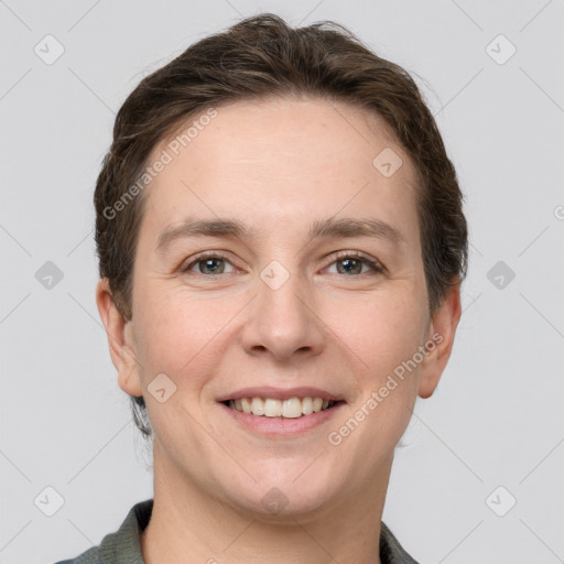 Joyful white young-adult female with short  brown hair and grey eyes