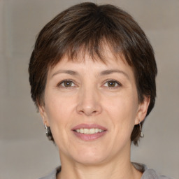 Joyful white adult female with short  brown hair and brown eyes