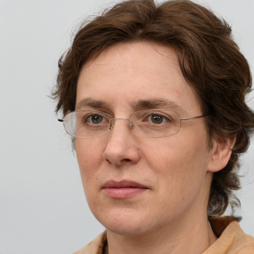 Joyful white adult female with medium  brown hair and green eyes