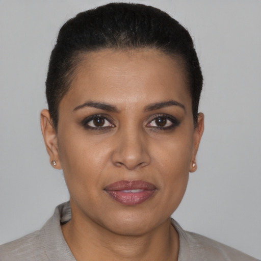 Joyful black young-adult female with short  brown hair and brown eyes