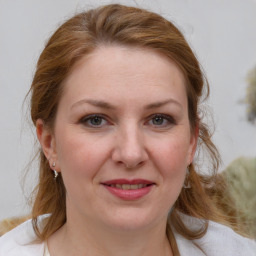 Joyful white young-adult female with medium  brown hair and blue eyes