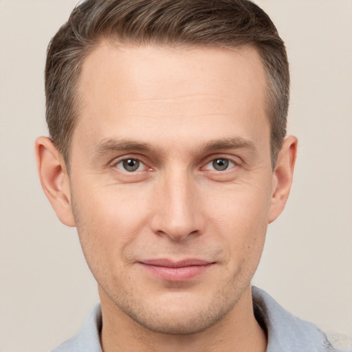 Joyful white adult male with short  brown hair and brown eyes