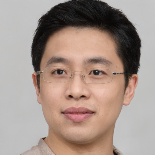 Joyful asian young-adult male with short  brown hair and brown eyes
