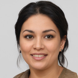 Joyful latino young-adult female with medium  brown hair and brown eyes