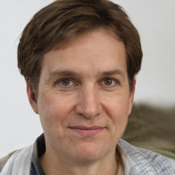 Joyful white adult male with short  brown hair and grey eyes