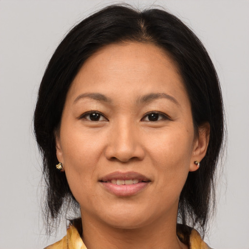 Joyful asian adult female with medium  brown hair and brown eyes