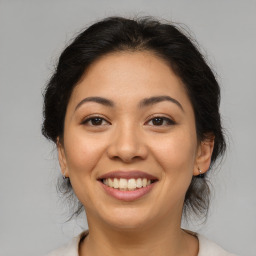 Joyful asian young-adult female with medium  brown hair and brown eyes