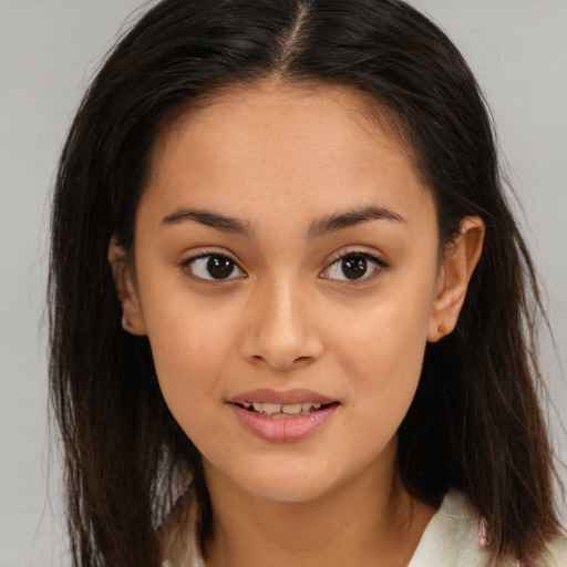 Joyful latino young-adult female with long  brown hair and brown eyes