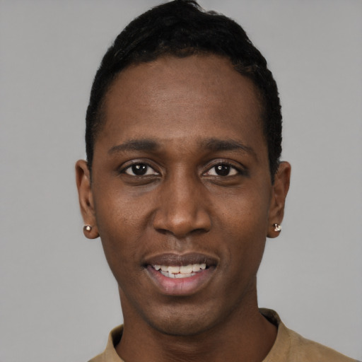 Joyful black young-adult male with short  black hair and brown eyes