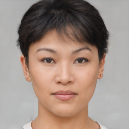 Joyful asian young-adult female with short  brown hair and brown eyes