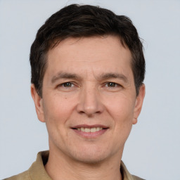 Joyful white adult male with short  brown hair and brown eyes