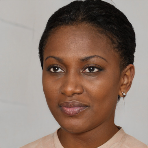 Joyful black young-adult female with short  black hair and brown eyes