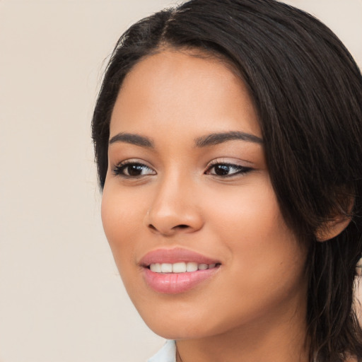 Joyful white young-adult female with long  black hair and brown eyes