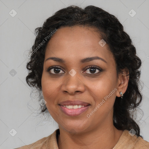 Joyful black young-adult female with long  brown hair and brown eyes