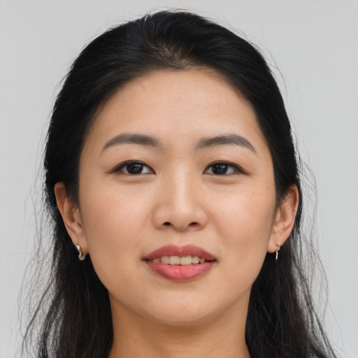 Joyful asian young-adult female with long  black hair and brown eyes