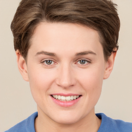 Joyful white young-adult female with short  brown hair and grey eyes