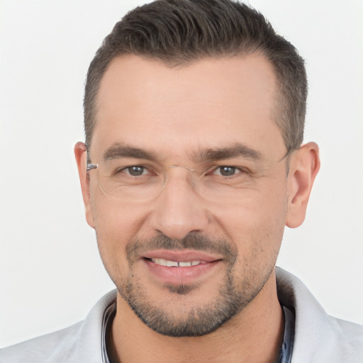 Joyful white young-adult male with short  black hair and brown eyes