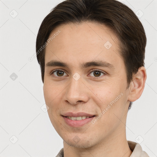 Joyful white young-adult male with short  brown hair and brown eyes