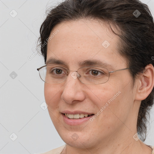 Joyful white adult female with medium  brown hair and brown eyes