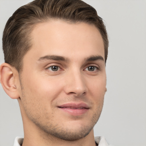 Joyful white young-adult male with short  brown hair and brown eyes