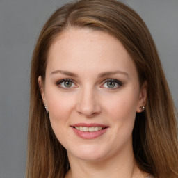 Joyful white young-adult female with long  brown hair and grey eyes