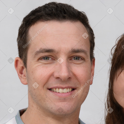 Joyful white young-adult male with short  brown hair and brown eyes