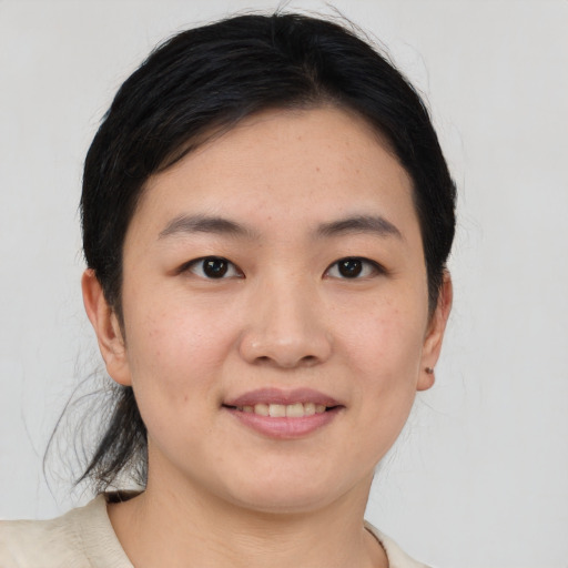 Joyful asian young-adult female with medium  brown hair and brown eyes