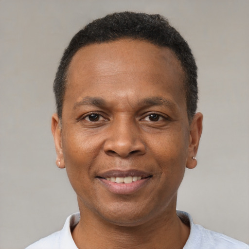 Joyful black adult male with short  brown hair and brown eyes