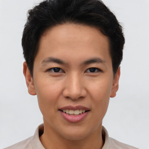 Joyful asian young-adult male with short  brown hair and brown eyes