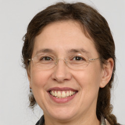 Joyful white adult female with medium  brown hair and grey eyes