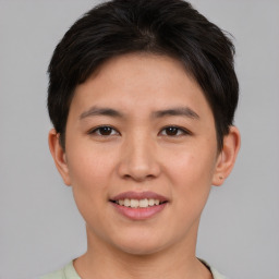 Joyful asian young-adult female with short  brown hair and brown eyes