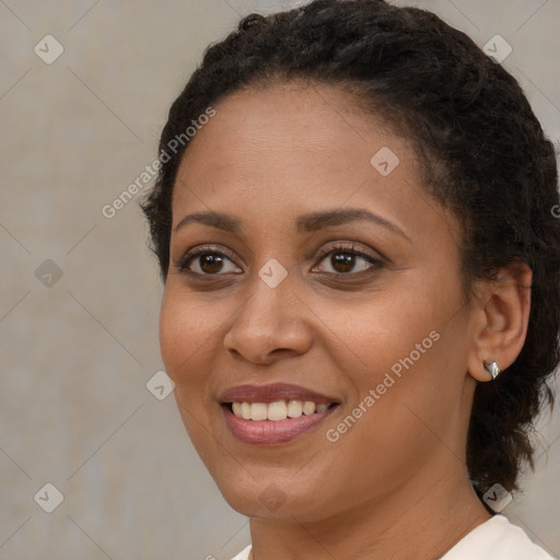 Joyful black young-adult female with short  brown hair and brown eyes