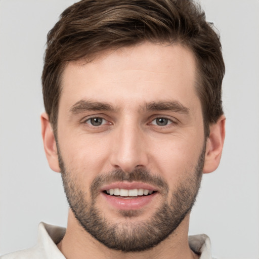 Joyful white young-adult male with short  brown hair and brown eyes