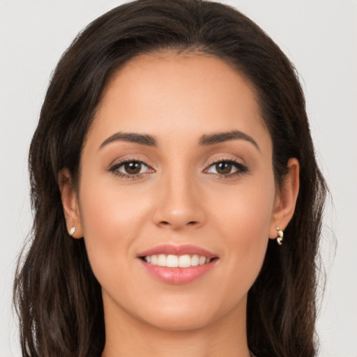 Joyful white young-adult female with long  brown hair and brown eyes