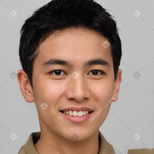 Joyful asian young-adult male with short  brown hair and brown eyes