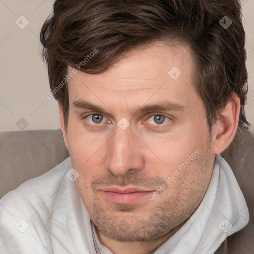 Joyful white adult male with short  brown hair and grey eyes