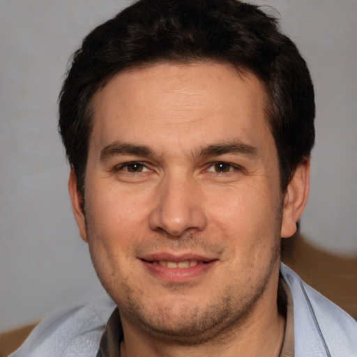 Joyful white adult male with short  brown hair and brown eyes