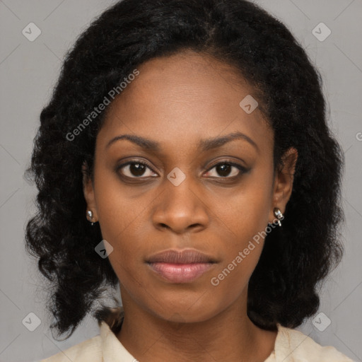 Joyful black young-adult female with long  black hair and brown eyes