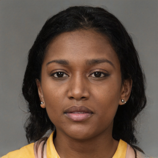 Neutral black young-adult female with medium  brown hair and brown eyes