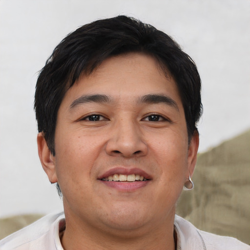 Joyful asian young-adult male with short  brown hair and brown eyes