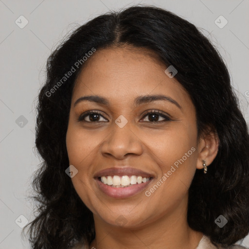 Joyful black young-adult female with long  brown hair and brown eyes