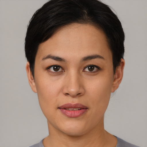 Joyful asian young-adult female with short  black hair and brown eyes