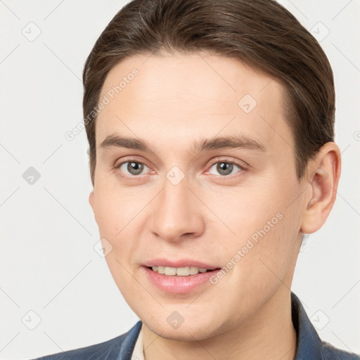 Joyful white young-adult male with short  brown hair and brown eyes