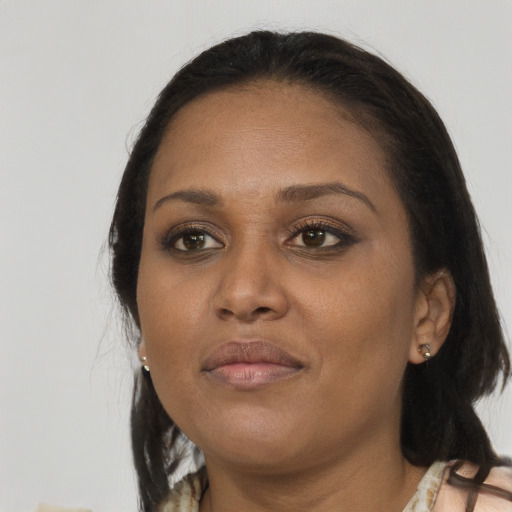 Joyful black adult female with medium  brown hair and brown eyes