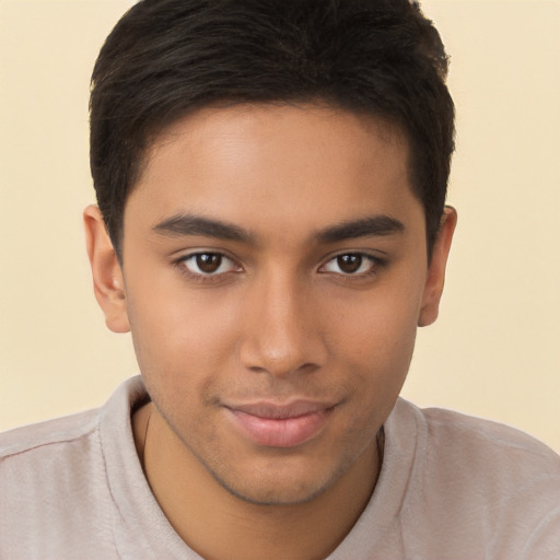 Joyful latino young-adult male with short  brown hair and brown eyes