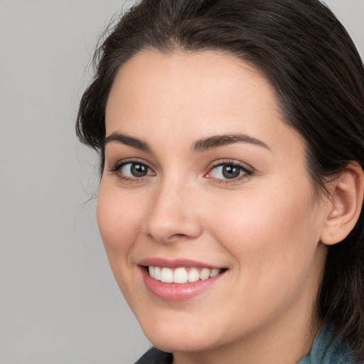 Joyful white young-adult female with long  brown hair and brown eyes